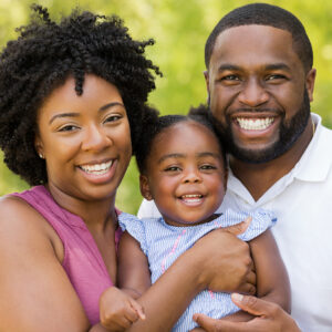 African American family laughing and smiling.