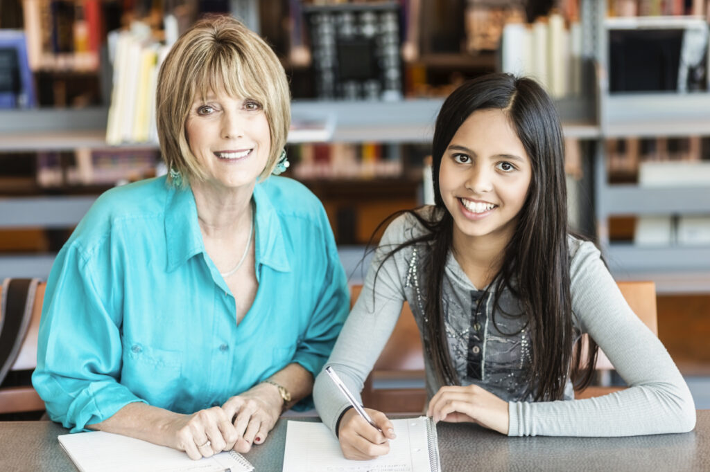 Older adult reading to child OASIS program related