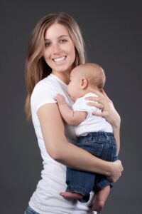 caucasian teenage girl holding infant boy resized